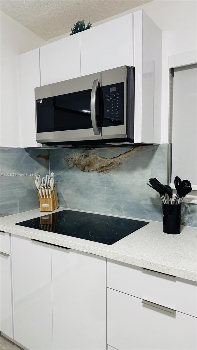 60 Southeast Marlin Avenue, Unit 2 Key Largo, FL 33037 - Photo 11 of 26 a close view of a microwave stove with kitchen island