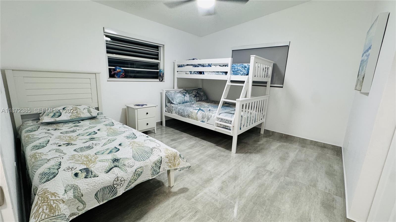 60 Southeast Marlin Avenue, Unit 2 Key Largo, FL 33037 - Photo 14 of 26 a bedroom with a bed and wooden floor