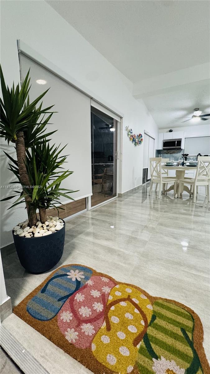 60 Southeast Marlin Avenue, Unit 2 Key Largo, FL 33037 - Photo 2 of 26 a living room with furniture and a potted plant