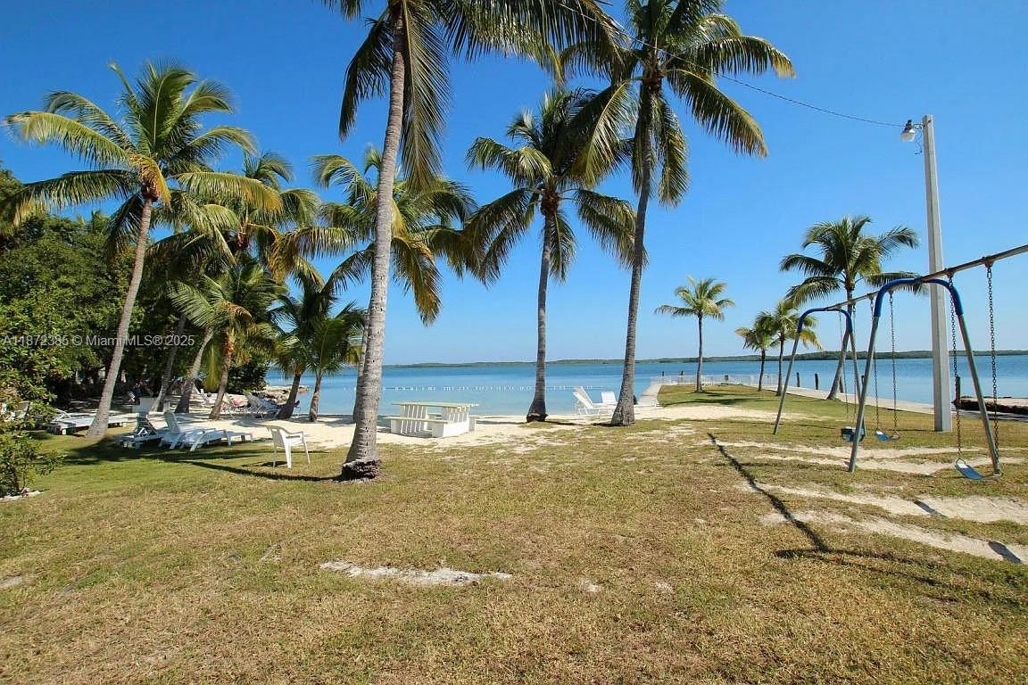 60 Southeast Marlin Avenue, Unit 2 Key Largo, FL 33037 - Photo 24 of 26 a view of a swimming pool with a house