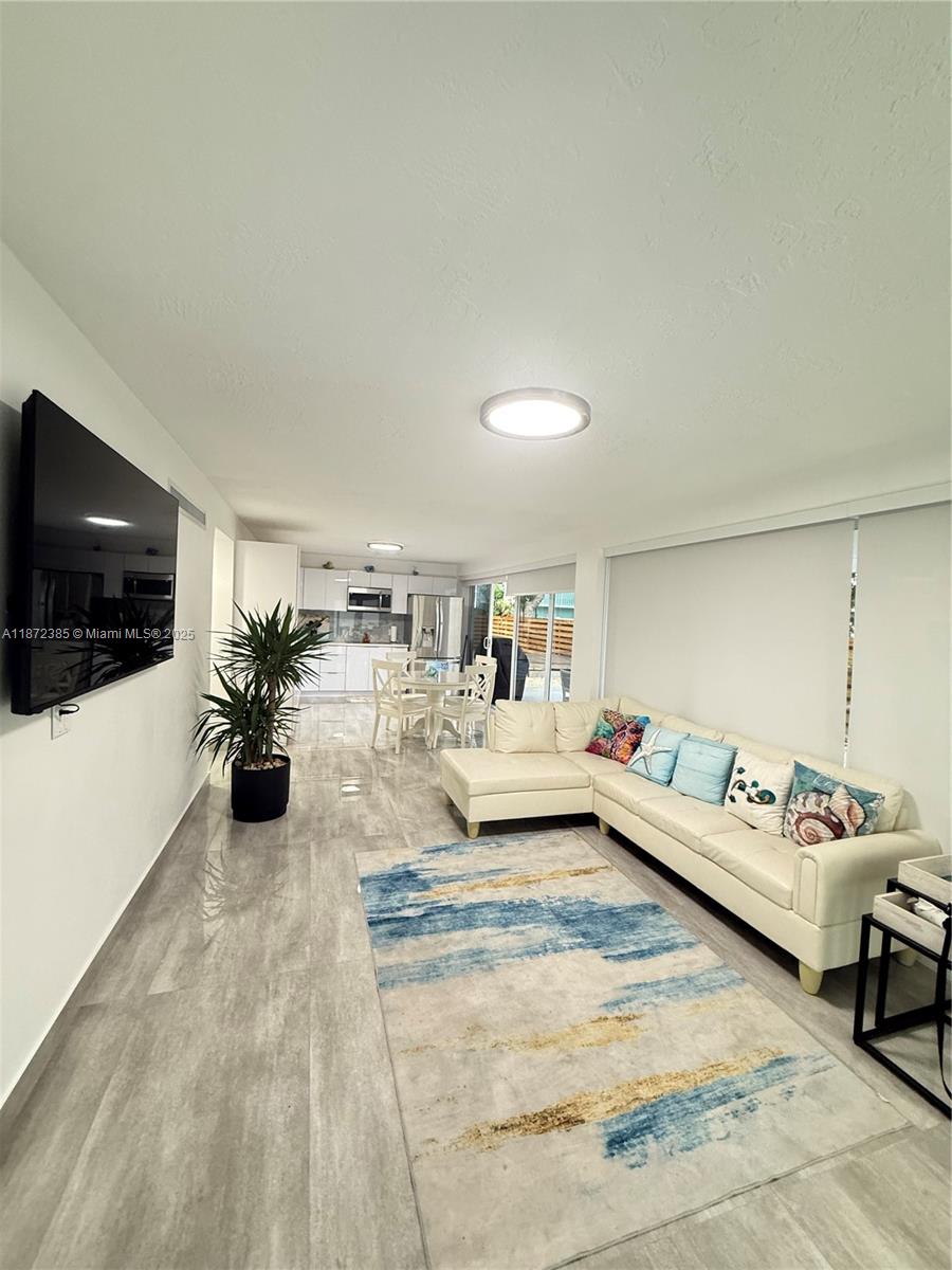 60 Southeast Marlin Avenue, Unit 2 Key Largo, FL 33037 - Photo 3 of 26 a living room with furniture and a flat screen tv