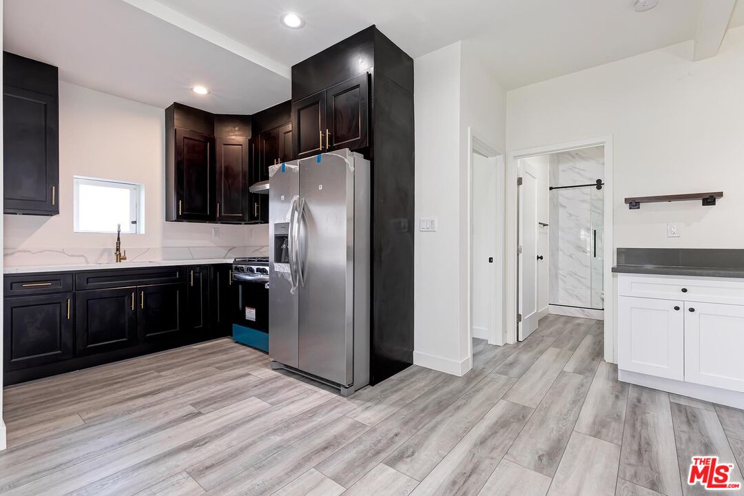 1054 Maine Avenue, Unit 2 Long Beach, CA 90813 - Photo 11 of 21 a kitchen with a refrigerator and a sink
