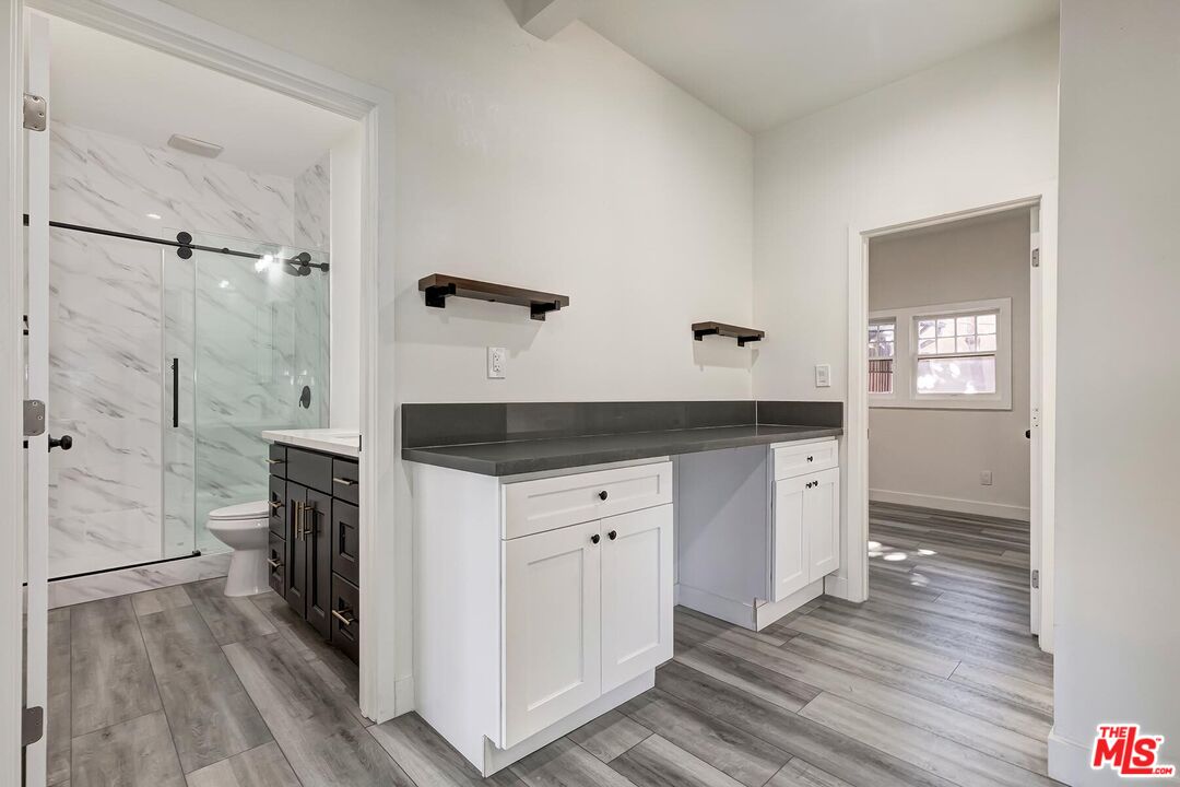 1054 Maine Avenue, Unit 2 Long Beach, CA 90813 - Photo 12 of 21 a spacious bathroom with a double vanity sink a large mirror and shower