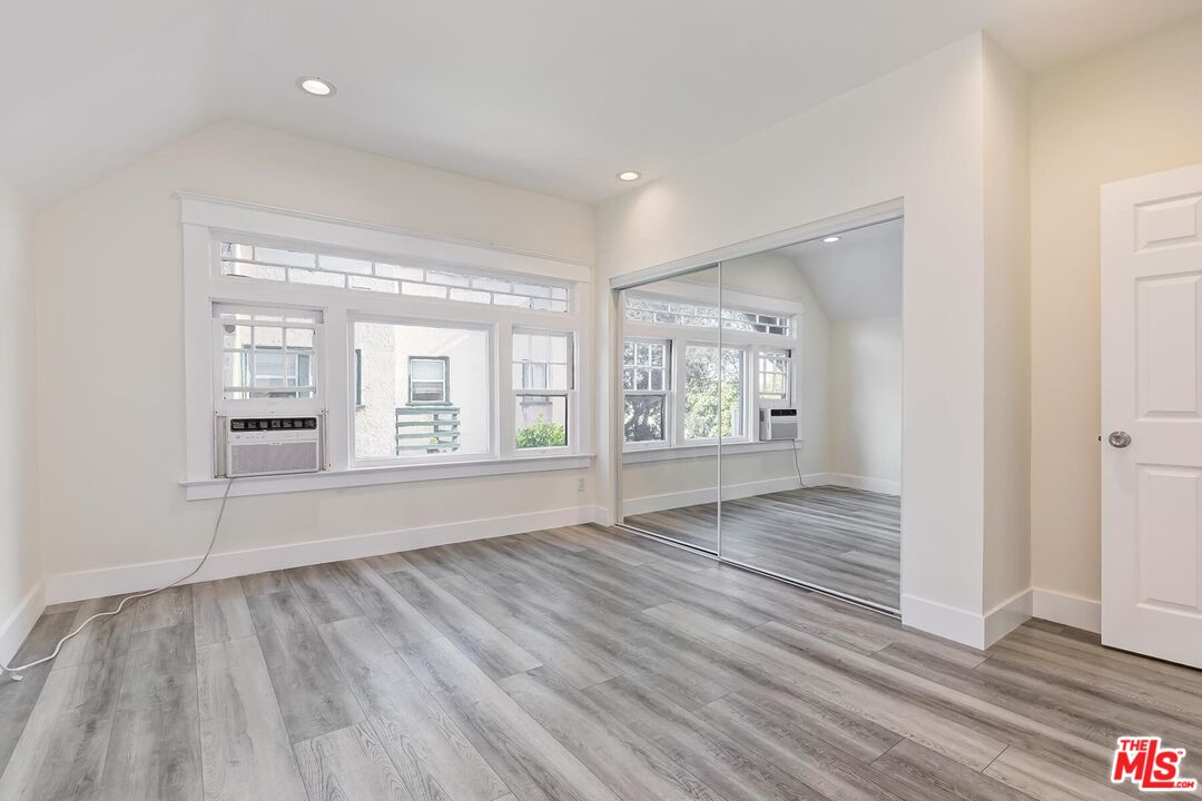 1054 Maine Avenue, Unit 2 Long Beach, CA 90813 - Photo 14 of 21 a view of an empty room with wooden floor and a window