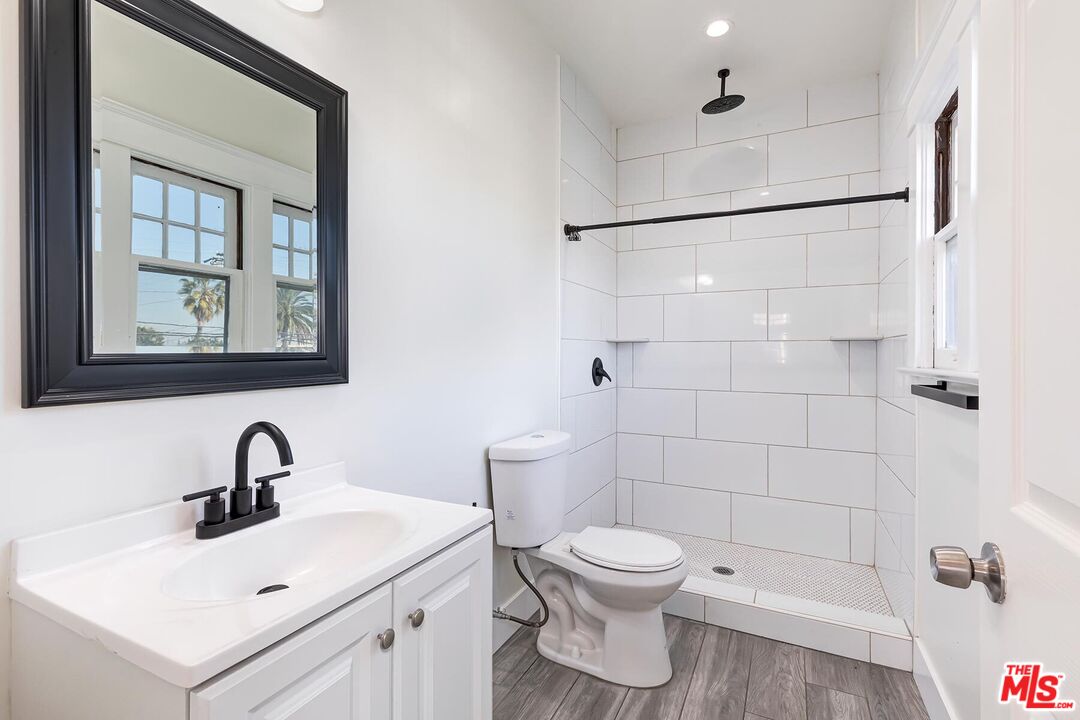 1054 Maine Avenue, Unit 2 Long Beach, CA 90813 - Photo 15 of 21 a bathroom with a sink toilet and shower