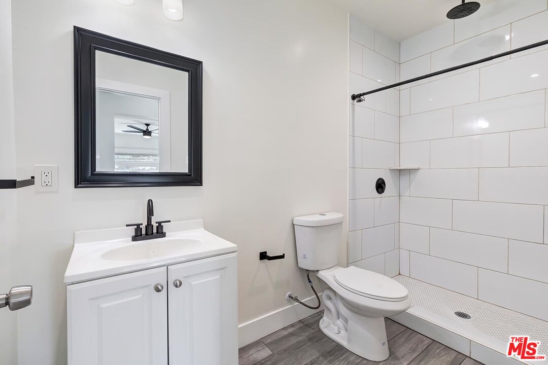 1054 Maine Avenue, Unit 2 Long Beach, CA 90813 - Photo 16 of 21 a bathroom with a toilet sink and mirror