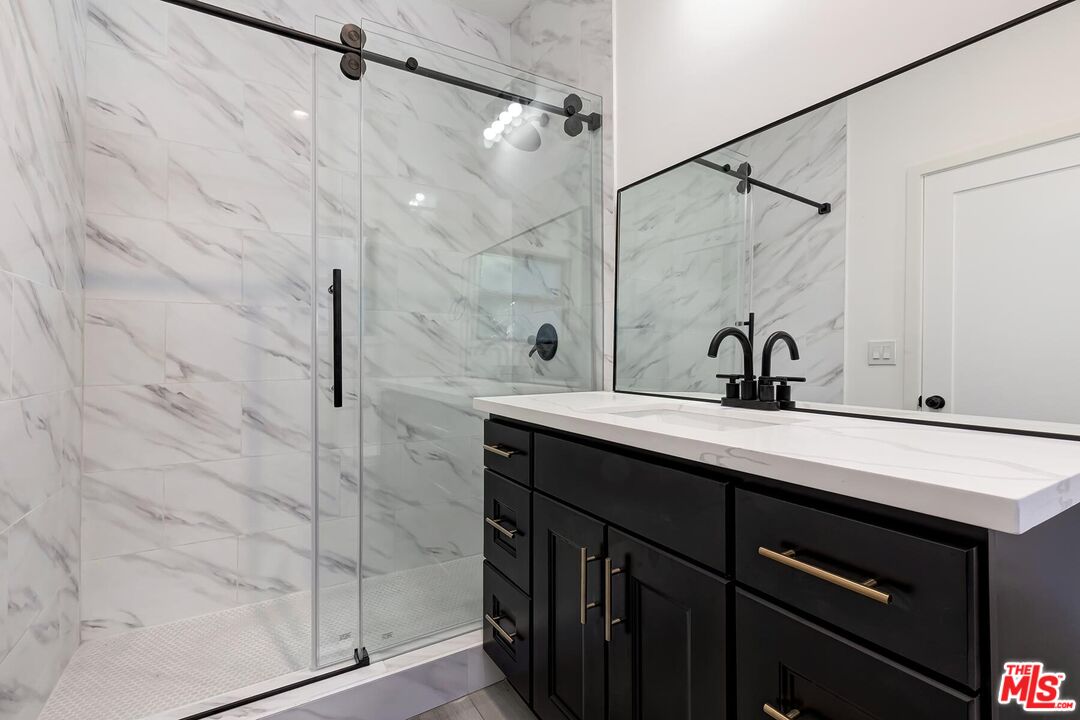 1054 Maine Avenue, Unit 2 Long Beach, CA 90813 - Photo 19 of 21 a bathroom with a double vanity sink a mirror and shower