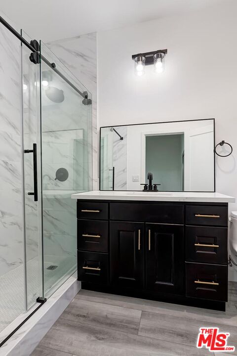 1054 Maine Avenue, Unit 2 Long Beach, CA 90813 - Photo 20 of 21 a bathroom with a double vanity sink and mirror