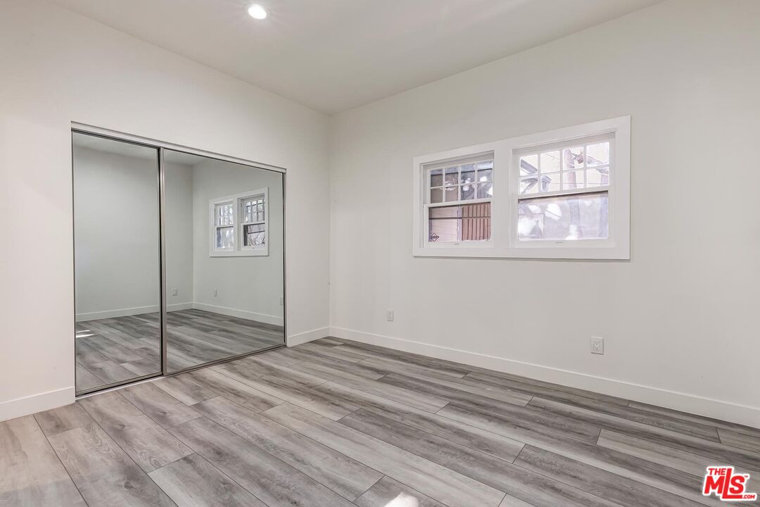1054 Maine Avenue, Unit 2 Long Beach, CA 90813 - Photo 21 of 21 a view of an empty room with wooden floor and a window