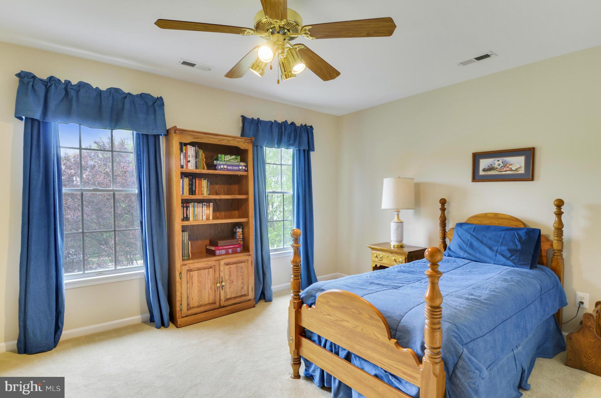 1327 Dasher Lane Reston, VA 20190 - Photo 23 of 30 a bed room with a bed and a book shelf