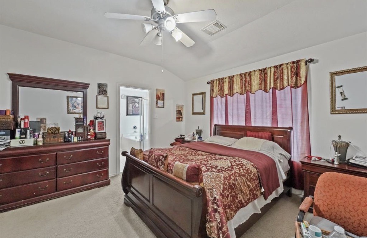 13134 Peppergate Lane Houston, TX 77044 - Photo 14 of 23 a bed room with a bed and a mirror on dresser