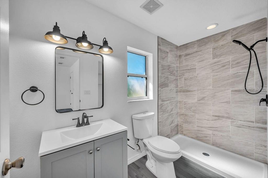 8695 Southwest 60th Circle Ocala, FL 34476 - Photo 13 of 19 a bathroom with a toilet sink and mirror