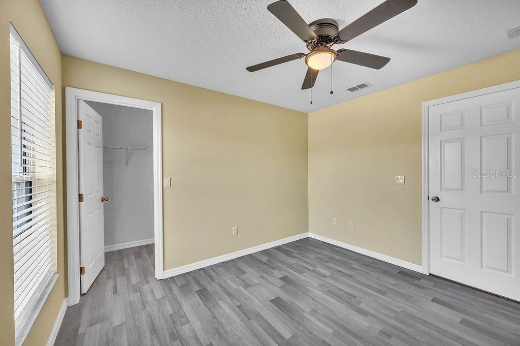 8695 Southwest 60th Circle Ocala, FL 34476 - Photo 18 of 19 wooden floor in an empty room with a window