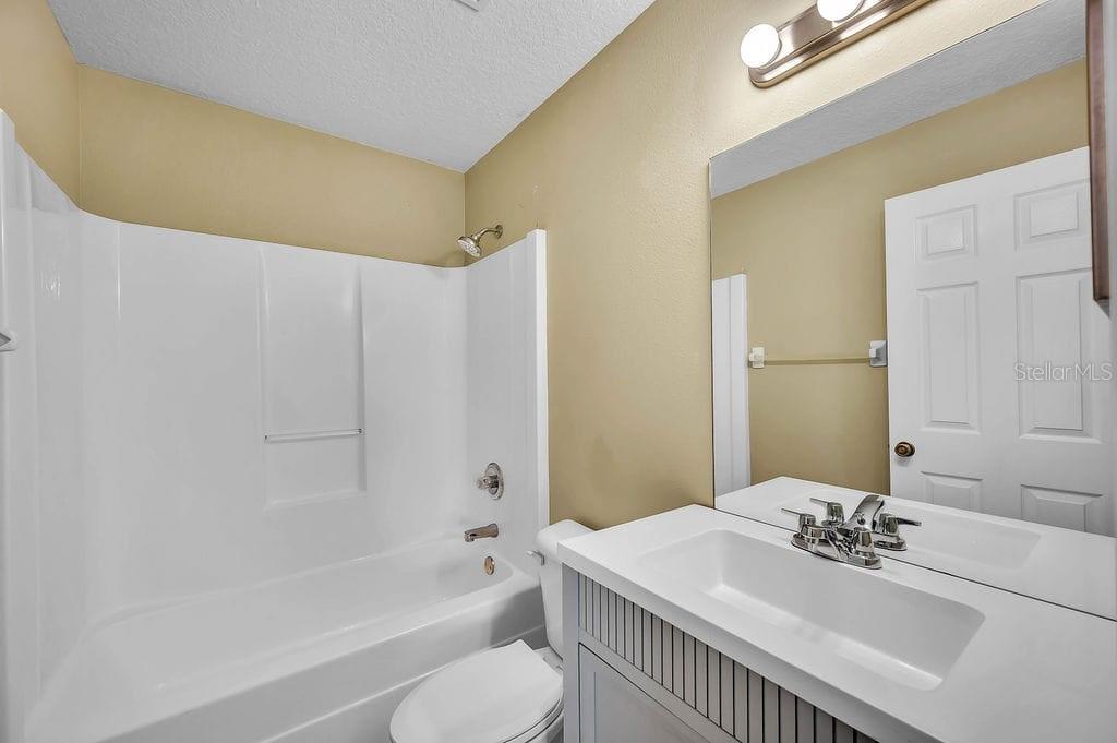 8695 Southwest 60th Circle Ocala, FL 34476 - Photo 19 of 19 a bathroom with a sink a toilet and shower