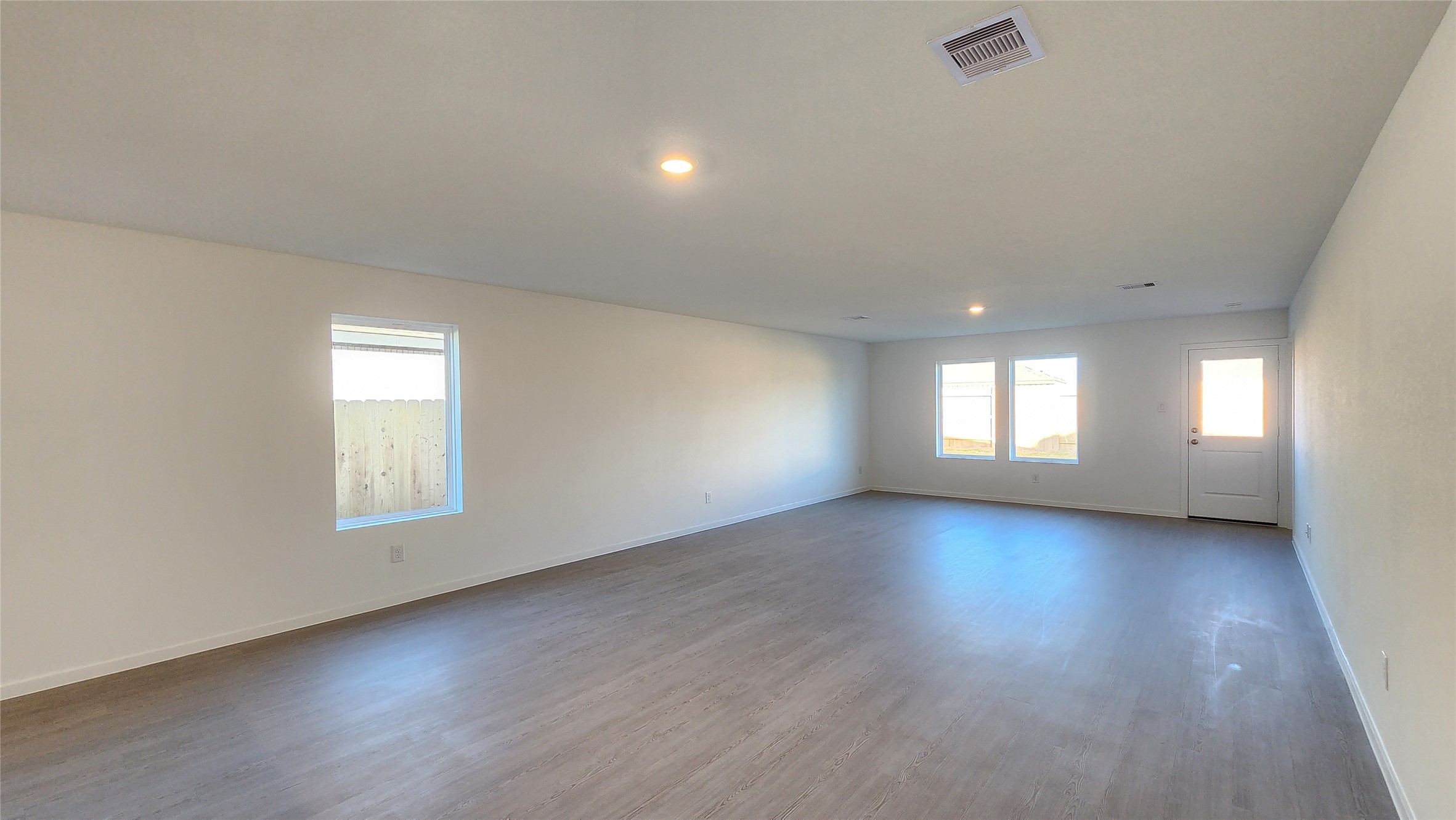 16210 Rustic Prairie Drive Hockley, TX 77447 - Photo 12 of 40 an empty room with wooden floor and windows