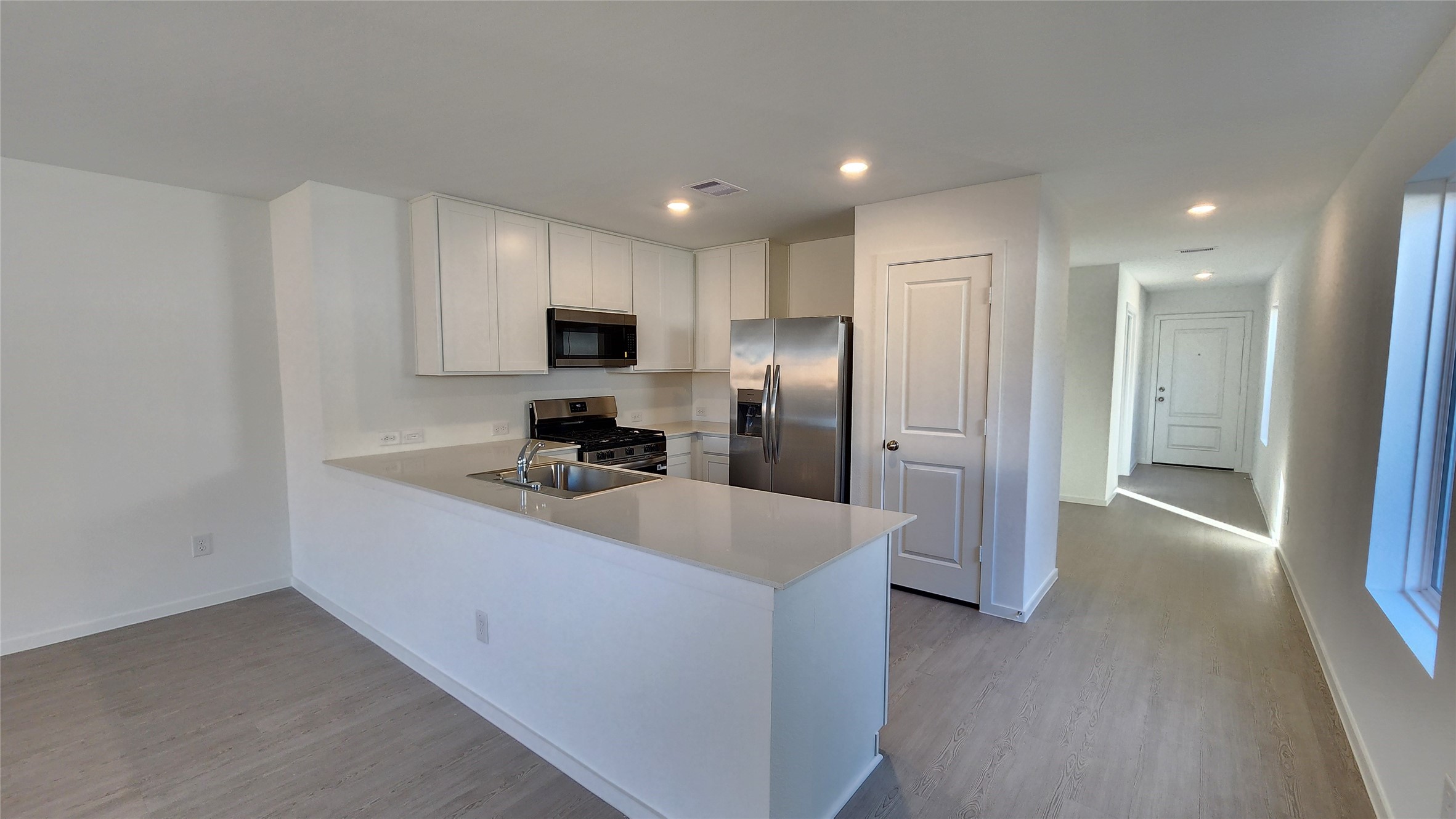 16210 Rustic Prairie Drive Hockley, TX 77447 - Photo 9 of 40 a kitchen with kitchen island a refrigerator sink and stove