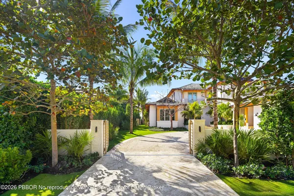 a front view of a house with a garden and yard