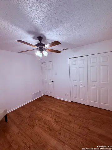 a view of walk in closet with wooden floor