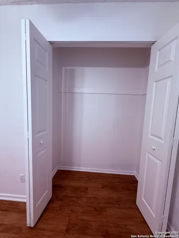 a living room with hard wood floors and a ceiling fan