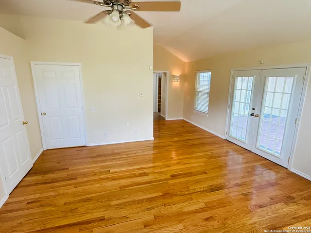a view of an empty room with a ceiling fan
