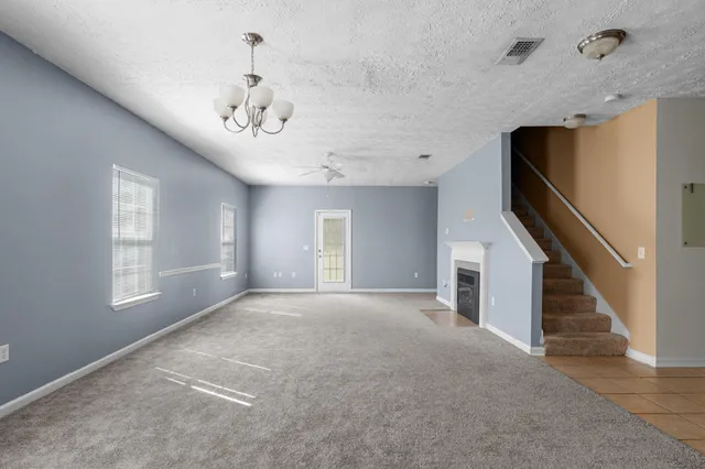 a spacious bathroom with a double vanity sink a toilet and a mirror