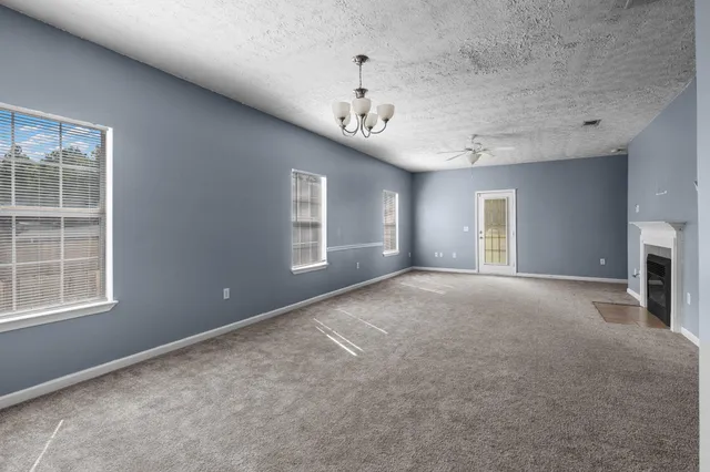 a view of an empty room with a ceiling fan