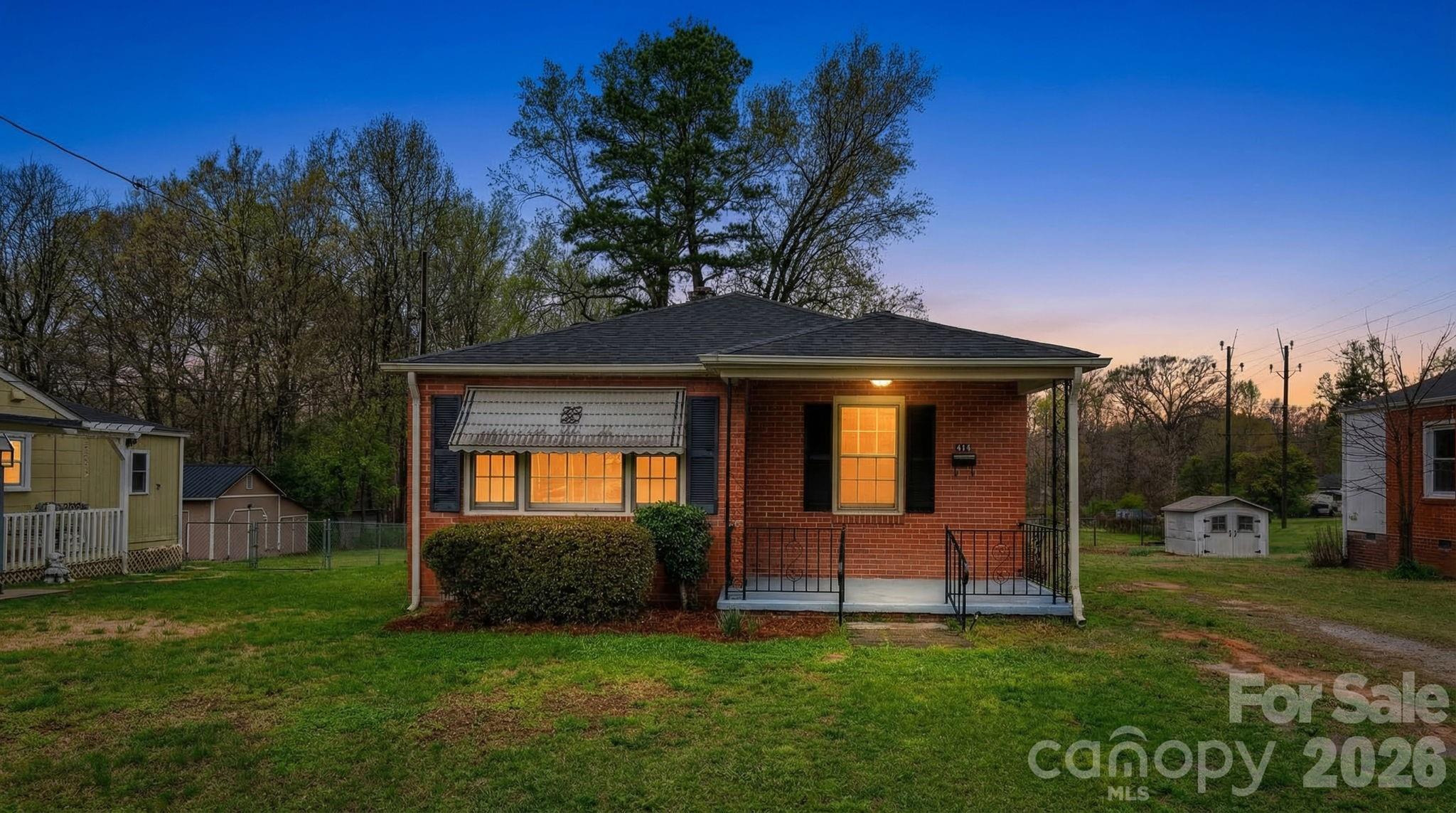 a view of a chair and table in backyard of the house