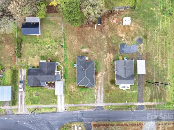 a aerial view of a brick house with a yard