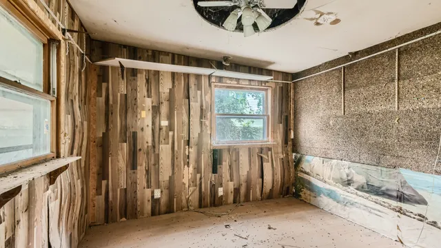 a view of a room with a window and a ceiling fan