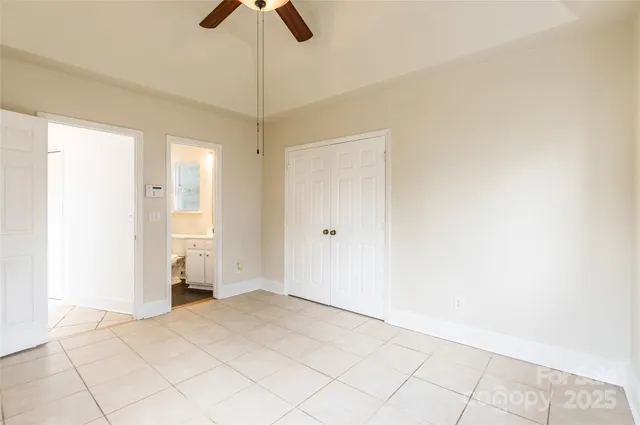 a view of empty room with ceiling fan