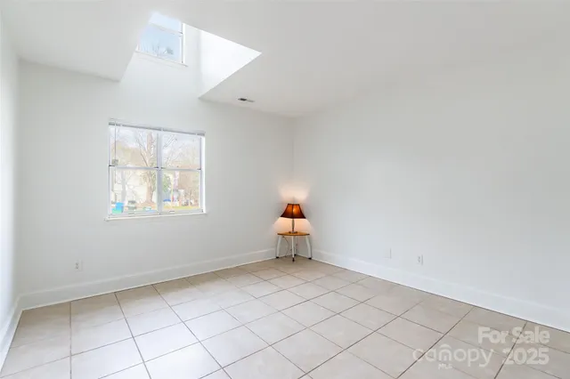 an empty room with a window and couch