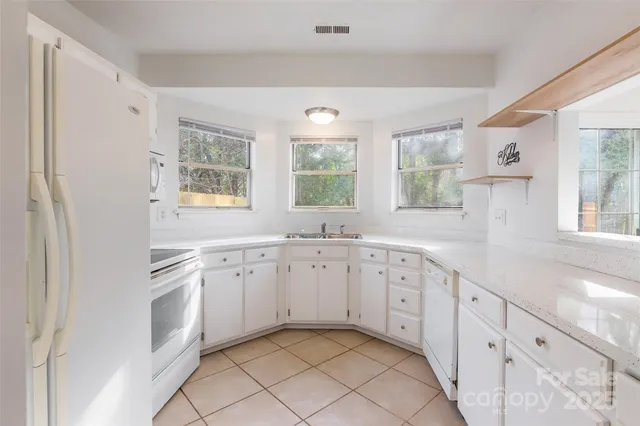 a spacious bathroom with a granite countertop sink mirror and a bathtub