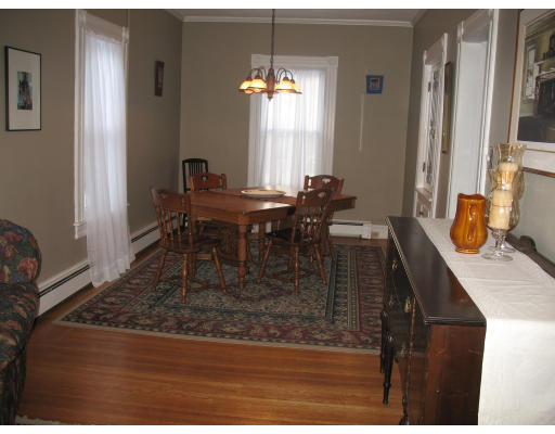 30 Churchill Street Springfield, MA 01108 - Photo 3 of 12 a dining room with table chairs and a chandelier
