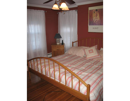 30 Churchill Street Springfield, MA 01108 - Photo 6 of 12 a bedroom with a bed and a chandelier