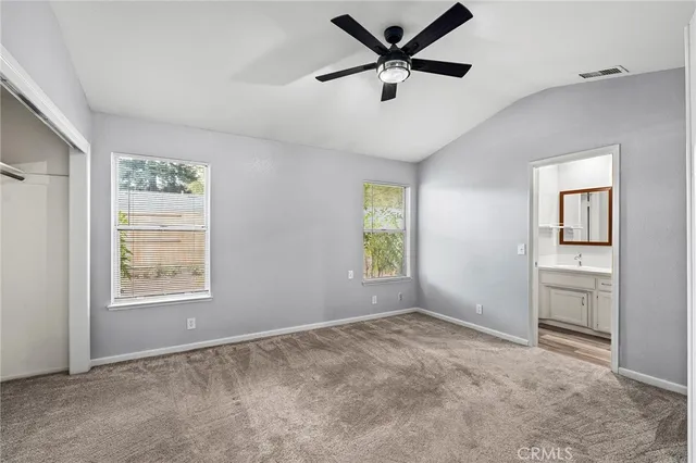 an empty room with windows and closet