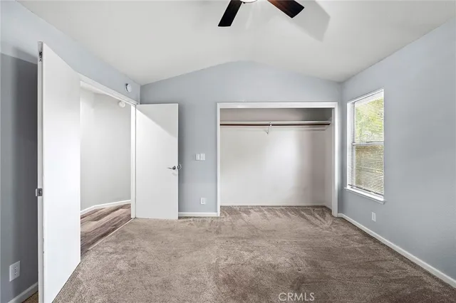 an empty room with windows and closet