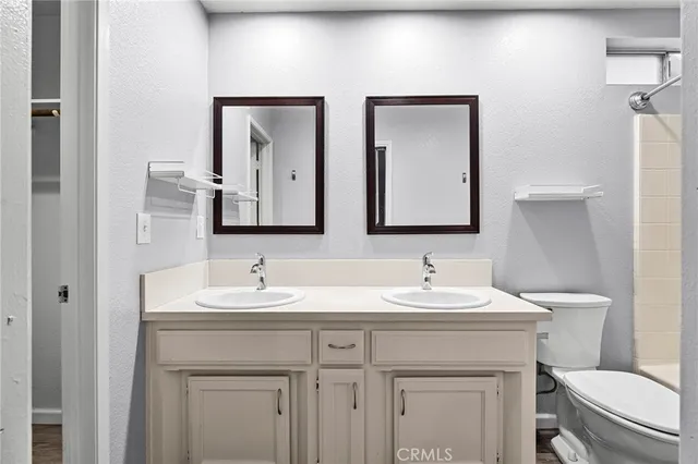 a bathroom with 2 sink and a toilet