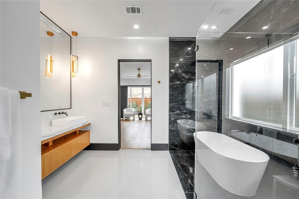 4721 Linnet Lane Dallas, TX 75209 - Photo 14 of 40 a bathroom with a tub shower and sink