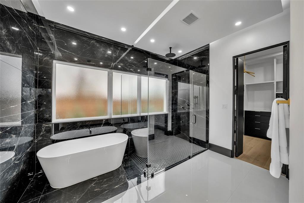 4721 Linnet Lane Dallas, TX 75209 - Photo 15 of 40 a bathroom with a bathtub and a shower