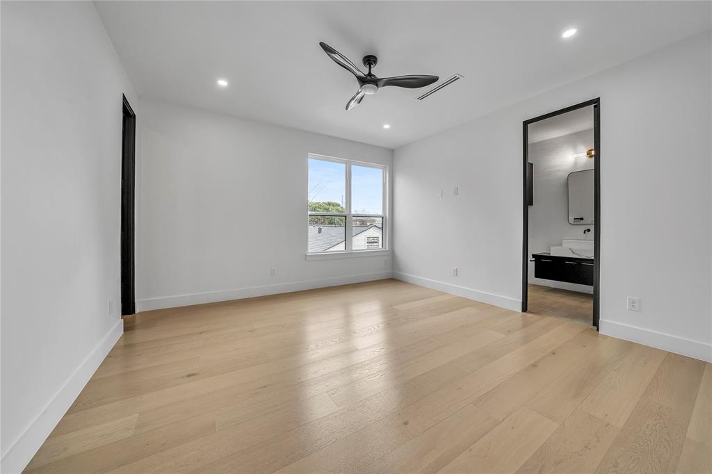 4721 Linnet Lane Dallas, TX 75209 - Photo 23 of 40 an empty room with a ceiling fan and windows