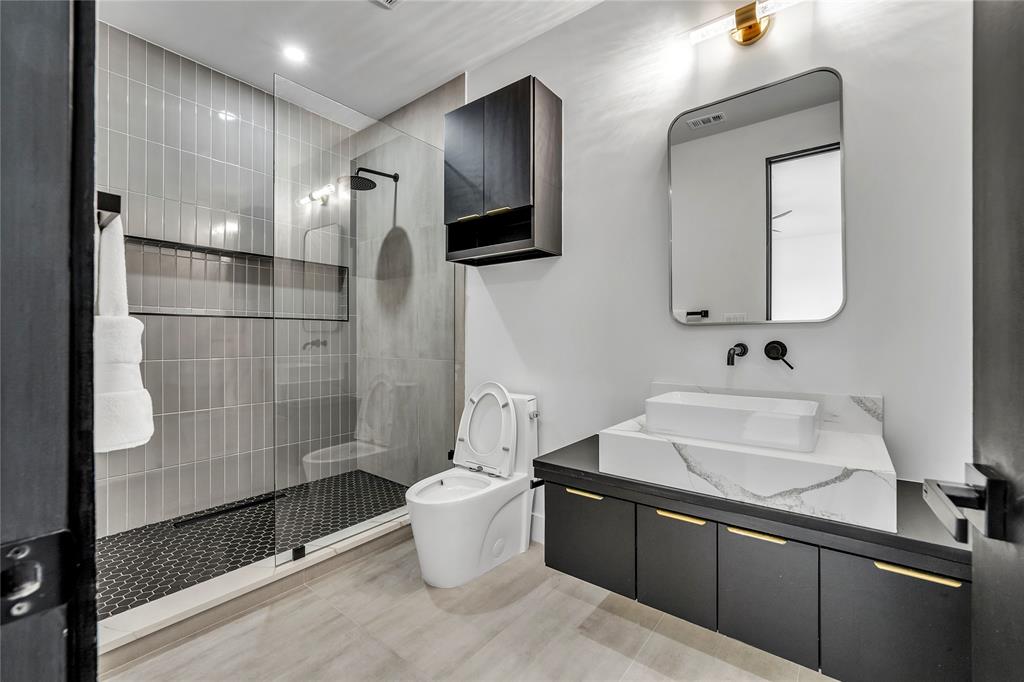 4721 Linnet Lane Dallas, TX 75209 - Photo 24 of 40 a bathroom with a sink toilet and shower