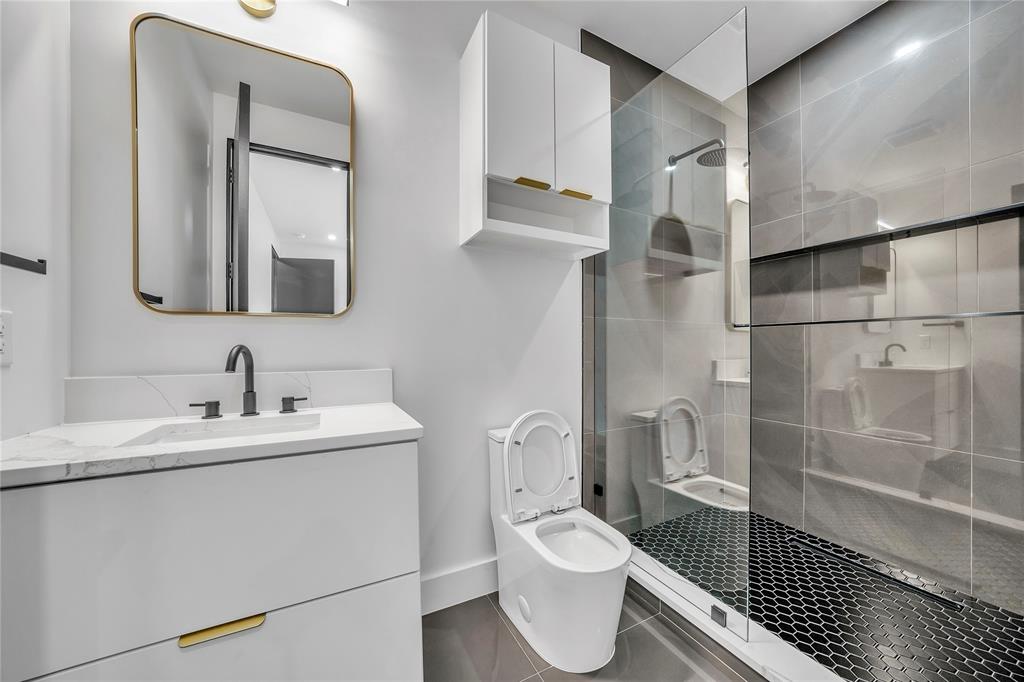 4721 Linnet Lane Dallas, TX 75209 - Photo 25 of 40 a white toilet sitting next to a bathroom sink