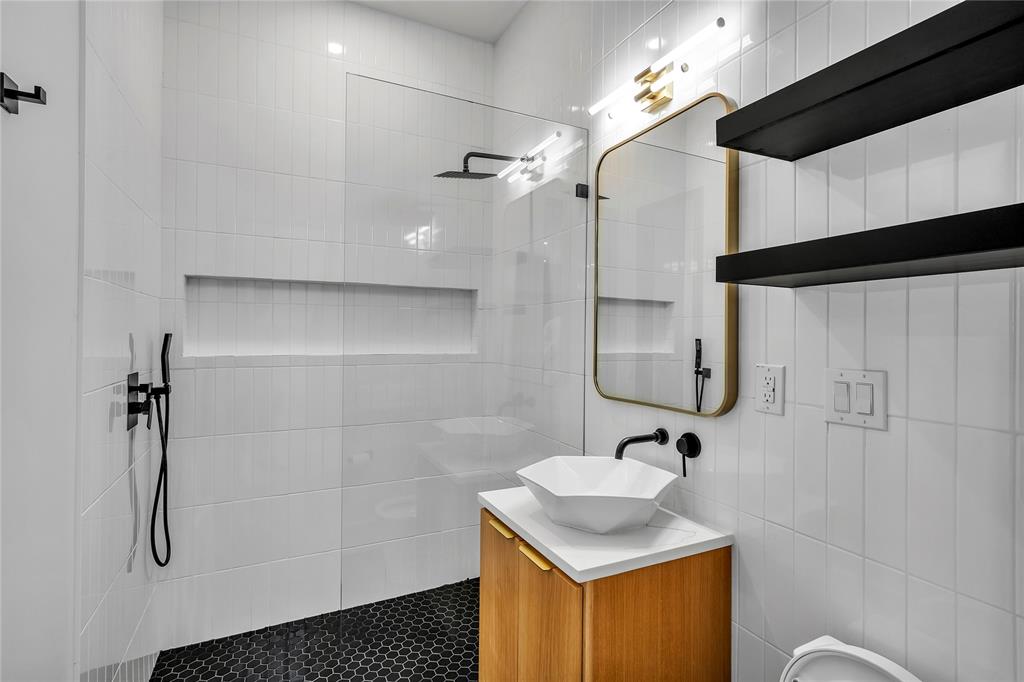 4721 Linnet Lane Dallas, TX 75209 - Photo 34 of 40 a bathroom with a sink shower and a mirror