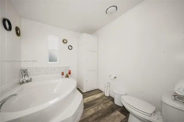 a white bath tub sitting next to a white toilet