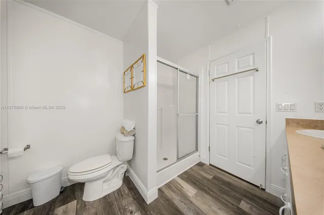 a bathroom with a toilet a sink and shower