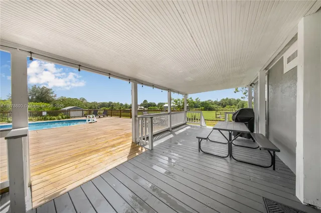 a view of balcony with furniture and wooden floor