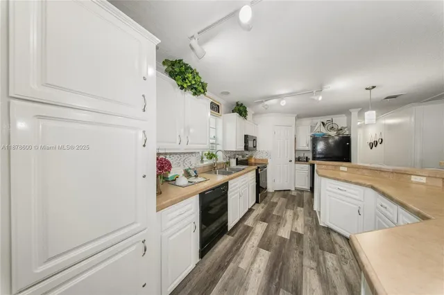a kitchen with white cabinets and white appliances