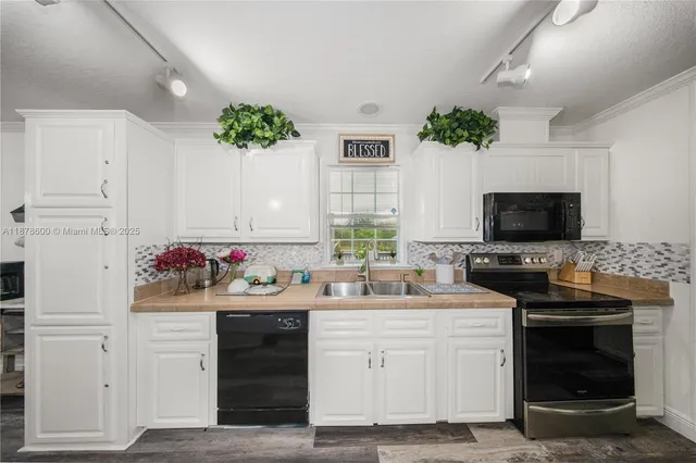 a kitchen with a sink stove and microwave