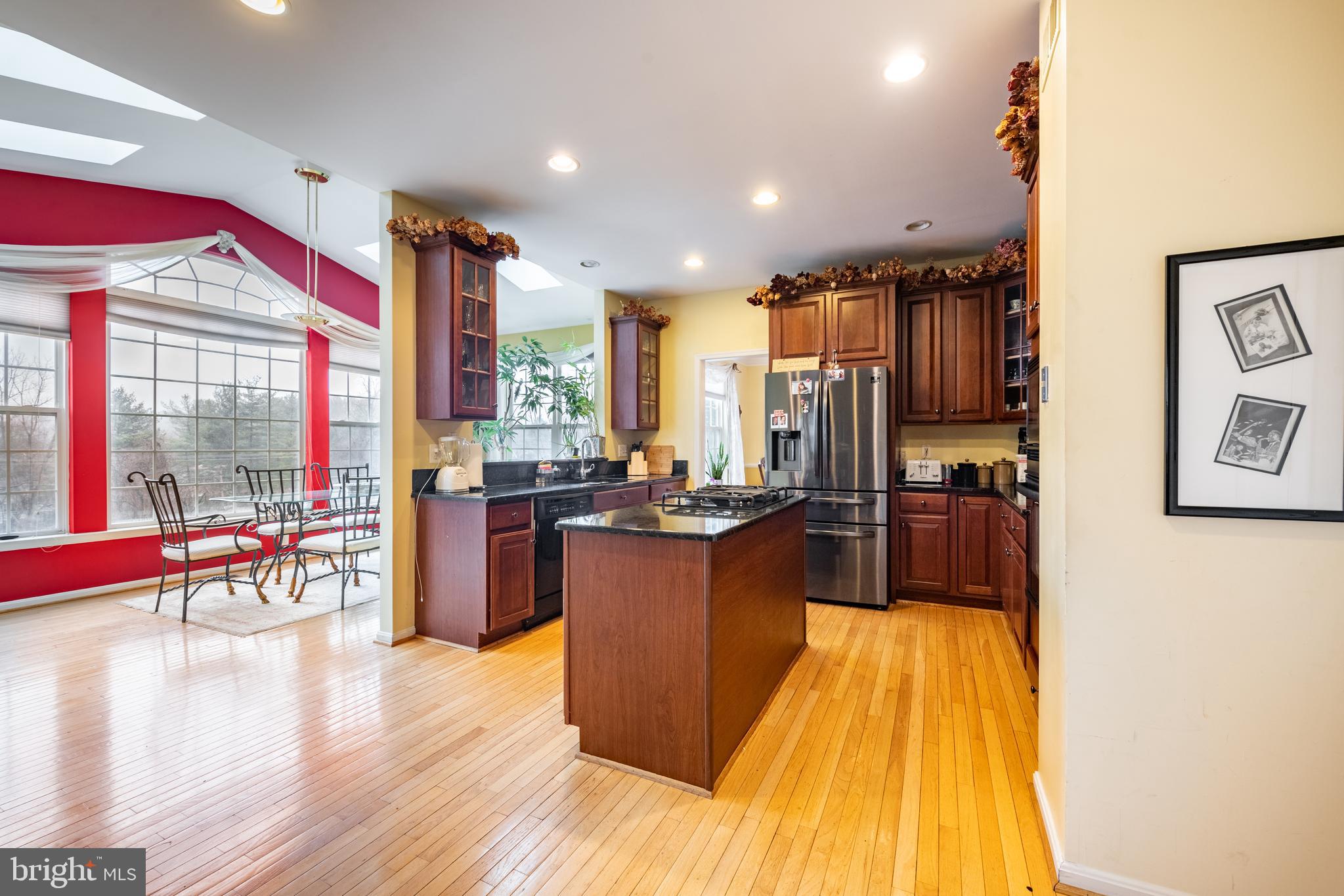 11 Manor Spring Court Silver Spring, MD 20906 - Photo 8 of 45 a kitchen with a table chairs and flat screen tv