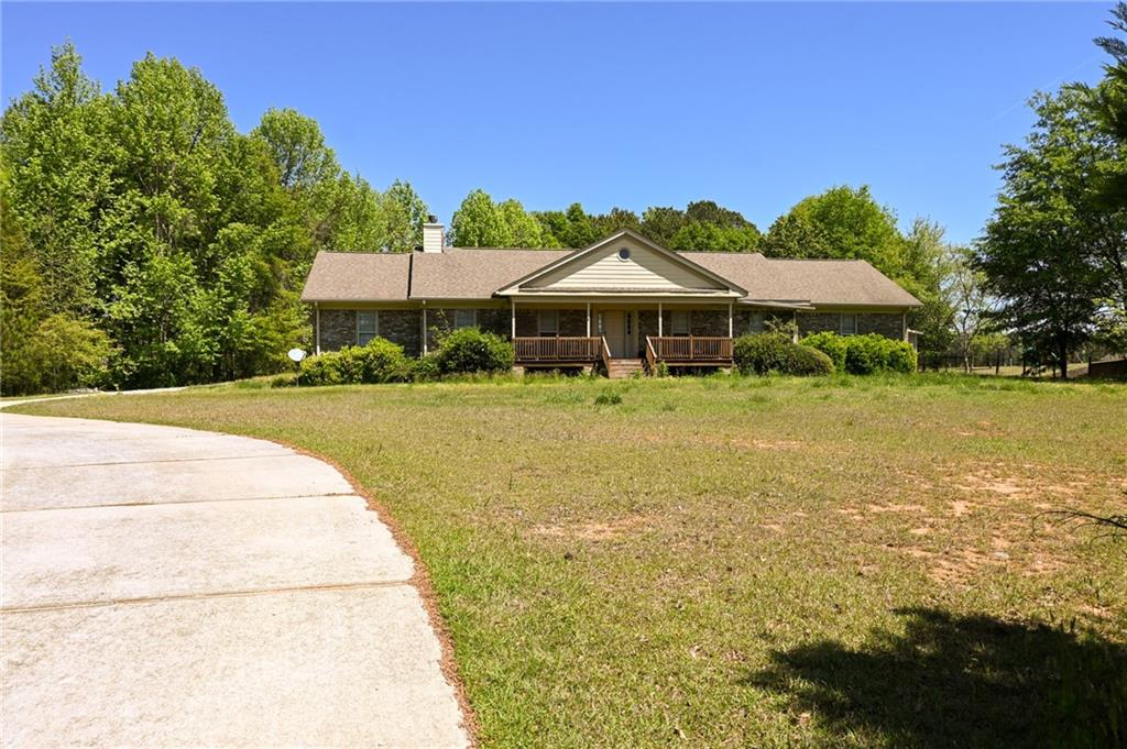 a view of a house with a yard and sitting area